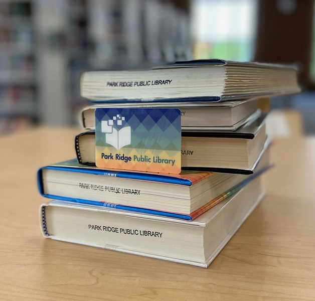 Stacked books with a library card