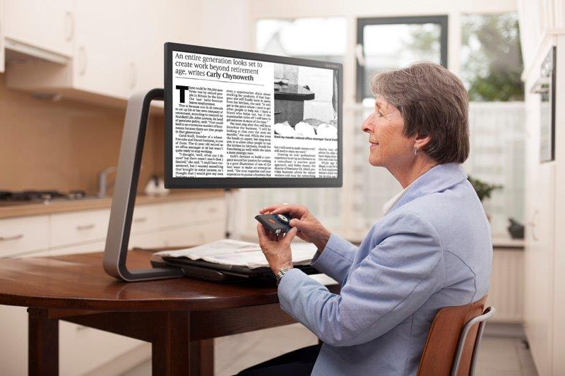 Person using a magnifying machine to read