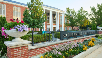 Photo of red brick exterior of Park Ridge Library building with sign in the foreground.